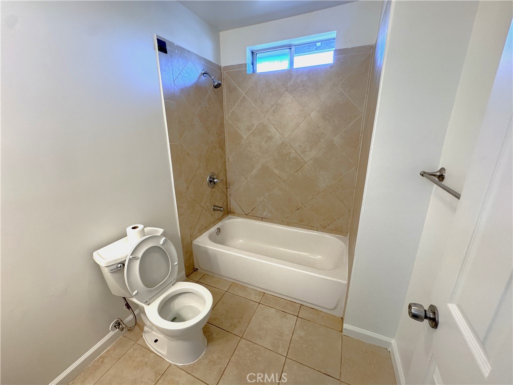 835 East Claude Street Carson, CA 90746 - Photo 14 of 20 a bathroom with a toilet and a bathtub