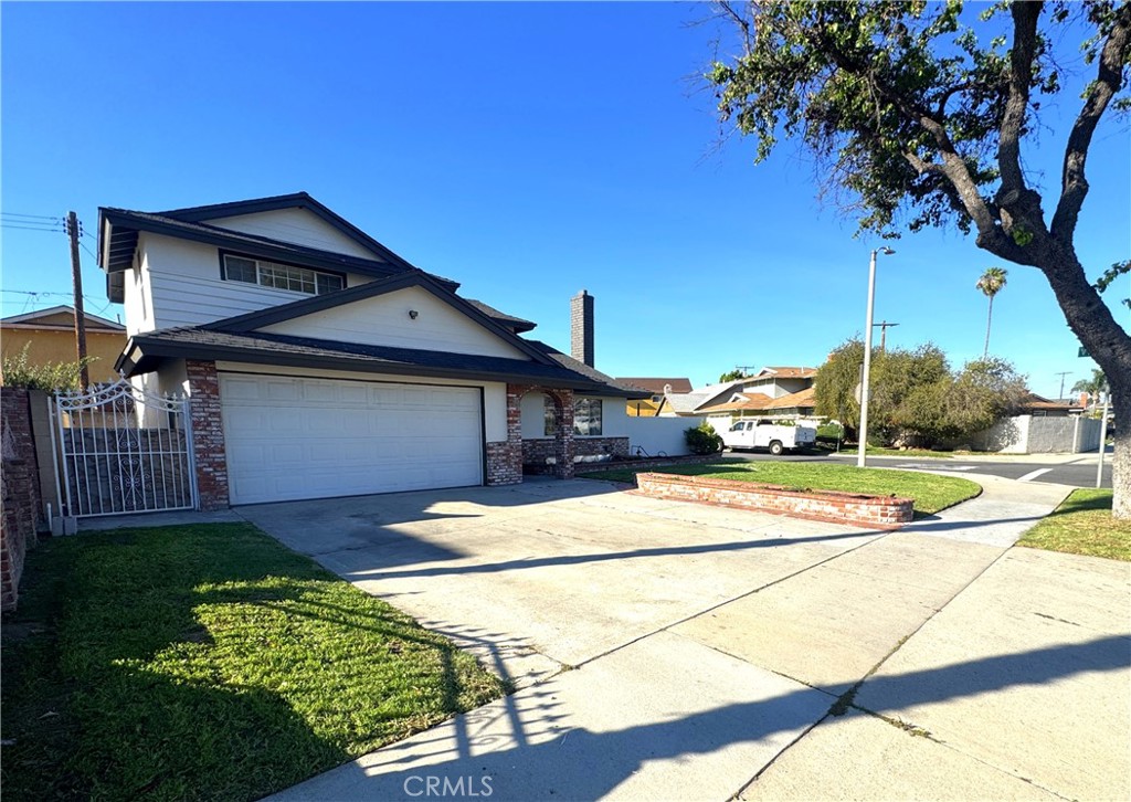 835 East Claude Street Carson, CA 90746 - Photo 2 of 20 a front view of a house with a yard and garage
