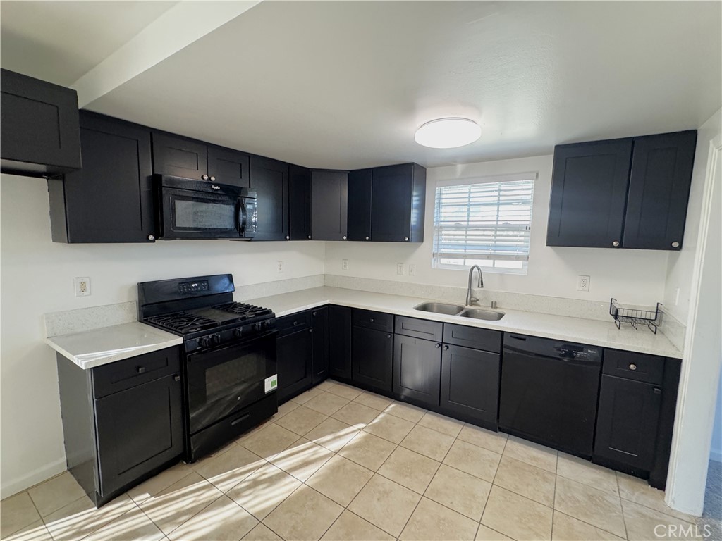 835 East Claude Street Carson, CA 90746 - Photo 6 of 20 a kitchen with a sink stove top oven and cabinets