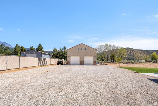 7776 Wagon Road East St. George, UT 84770 - Photo 53 of 76 Garage with a mountain view, a garage, and driveway