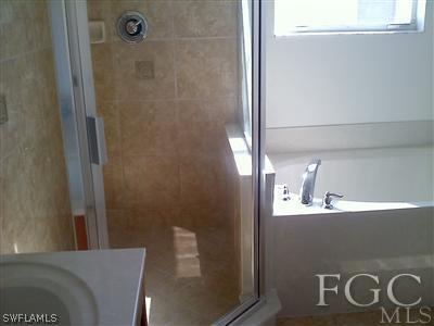 9803 Bodego Way, Unit 104 Fort Myers, FL 33908 - Photo 9 of 10 a bathroom with a sink and a mirror