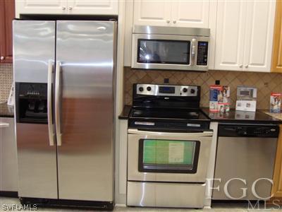 9803 Bodego Way, Unit 104 Fort Myers, FL 33908 - Photo 10 of 10 a kitchen with a stove and a microwave