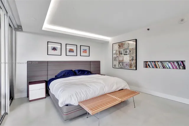 a bedroom with a bed and a wall painting