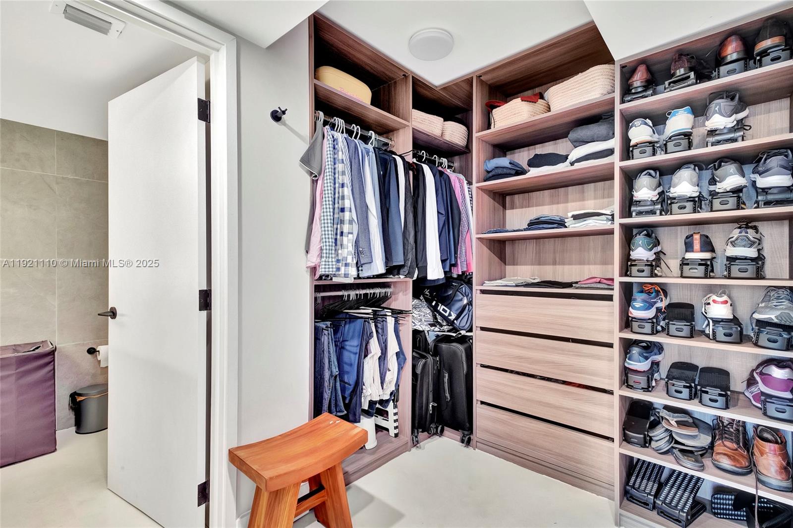 1627 Brickell Avenue, Unit 1202 Miami, FL 33129 - Photo 18 of 30 a view of walk in closet with clothes and shoes