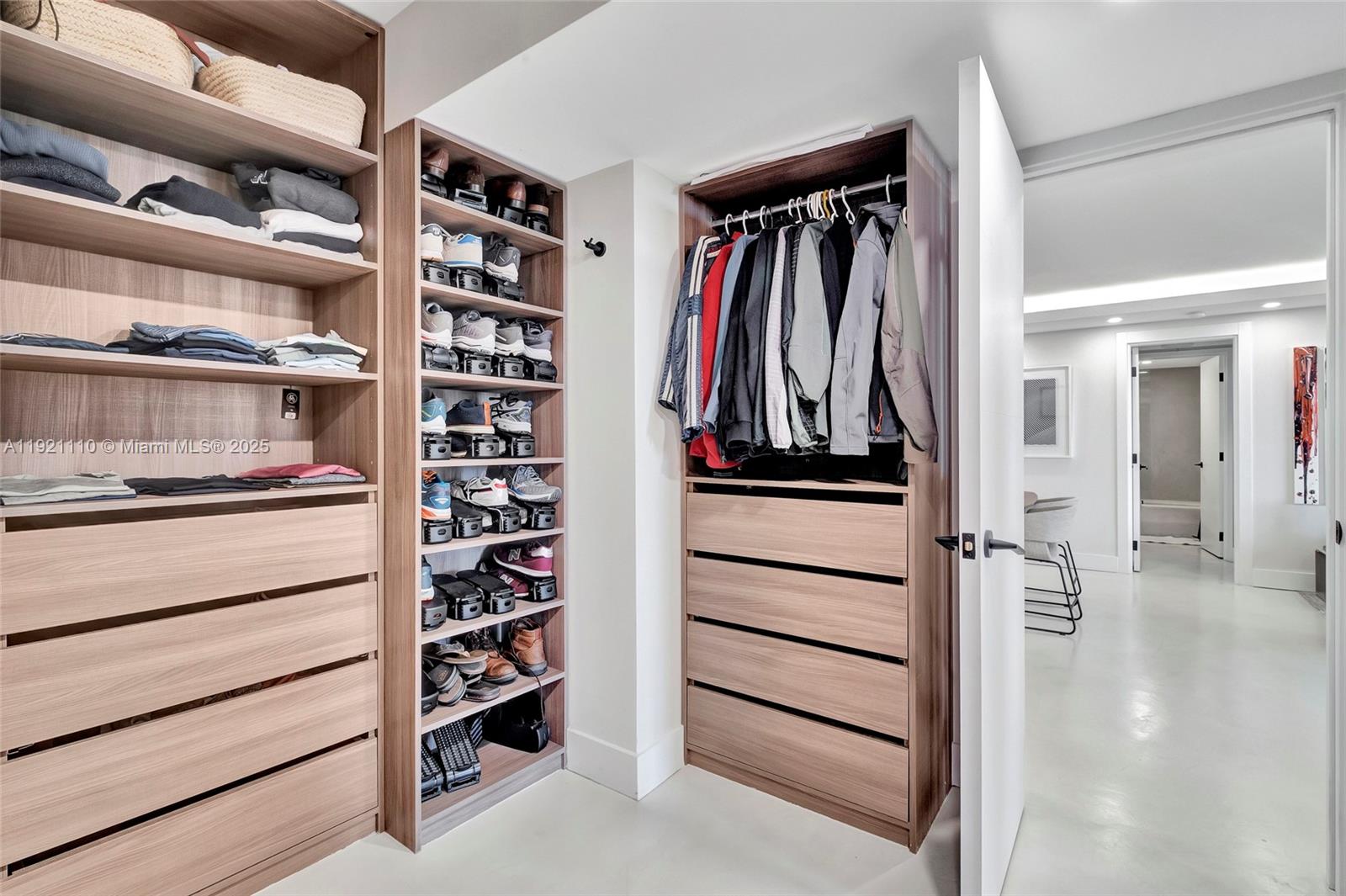 1627 Brickell Avenue, Unit 1202 Miami, FL 33129 - Photo 19 of 30 a view of walk in closet with clothes and shoes