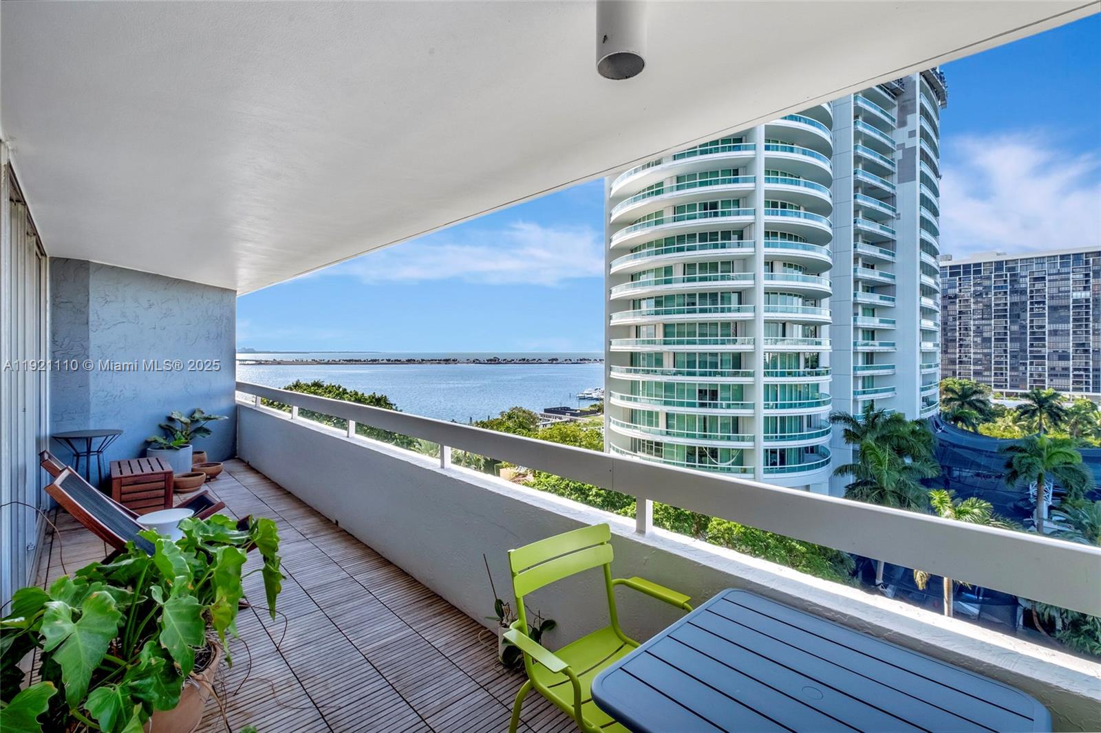1627 Brickell Avenue, Unit 1202 Miami, FL 33129 - Photo 4 of 30 a view of a balcony with chairs and wooden fence
