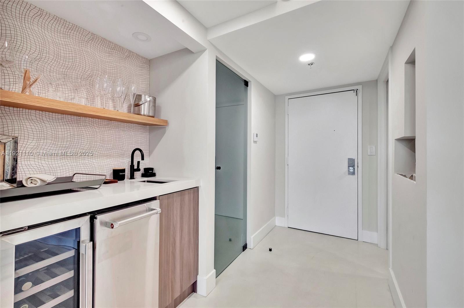 1627 Brickell Avenue, Unit 1202 Miami, FL 33129 - Photo 10 of 30 a kitchen with stainless steel appliances granite countertop a sink and cabinets