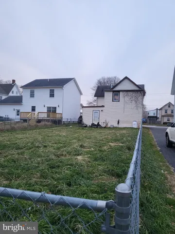 a front view of a house with a yard fire pit and outdoor seating