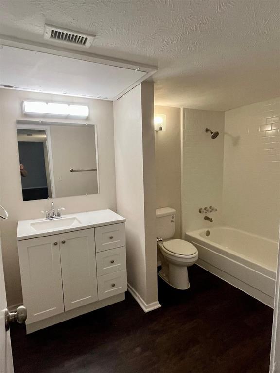 4851 Cedar Springs Road, Unit 391 Dallas, TX 75219 - Photo 8 of 14 a bathroom with a double vanity sink toilet mirror and bathtub