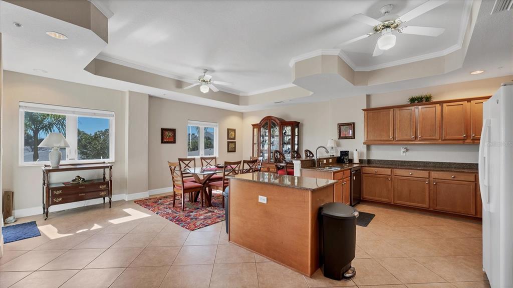 2245 North Beach Road, Unit 203 Englewood, FL 34223 - Photo 15 of 55 a kitchen with kitchen island granite countertop lots of counter top space and appliances