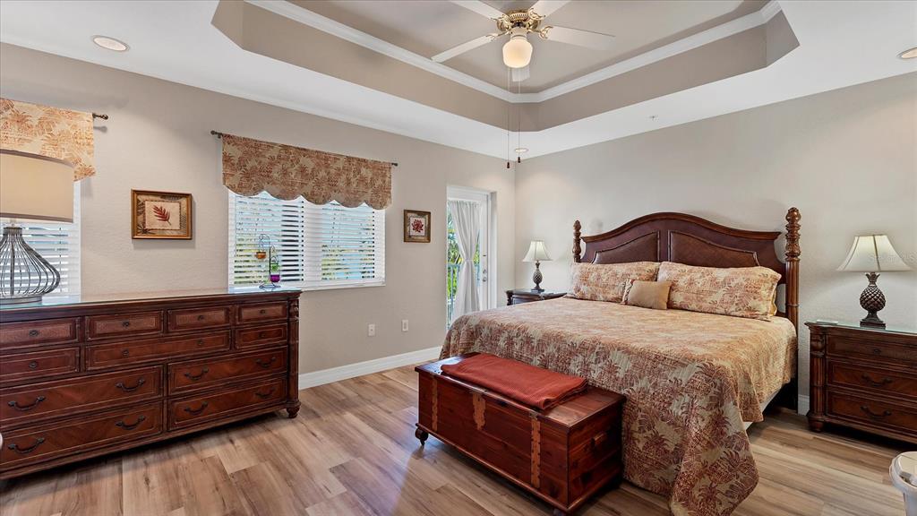 2245 North Beach Road, Unit 203 Englewood, FL 34223 - Photo 16 of 55 a bedroom with a bed and wooden floor
