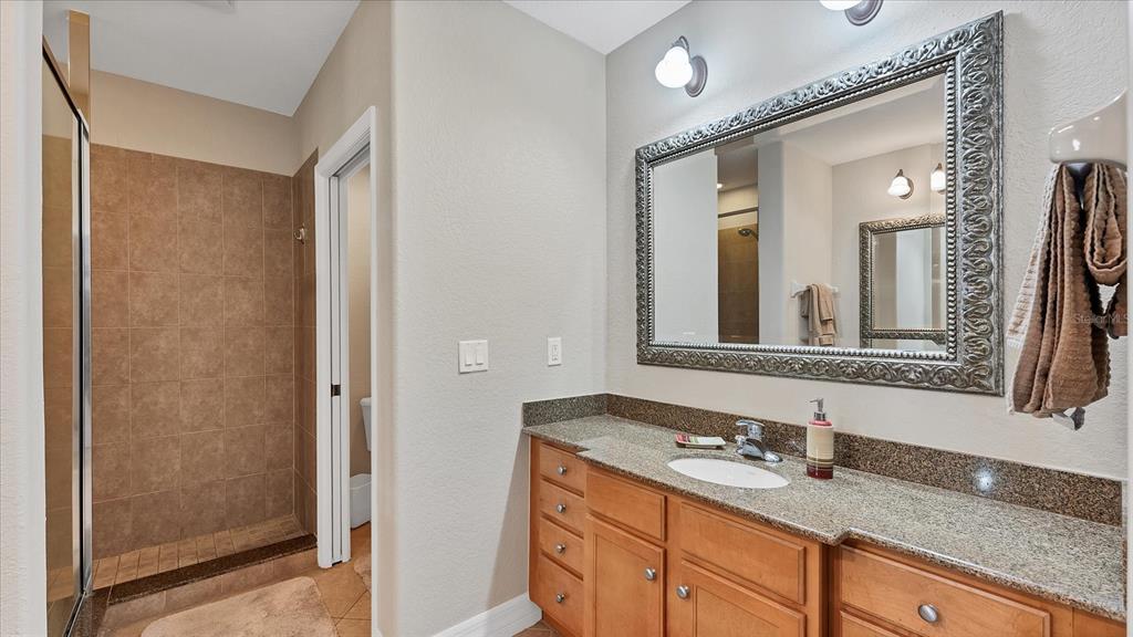 2245 North Beach Road, Unit 203 Englewood, FL 34223 - Photo 20 of 55 a bathroom with a granite countertop sink and a mirror