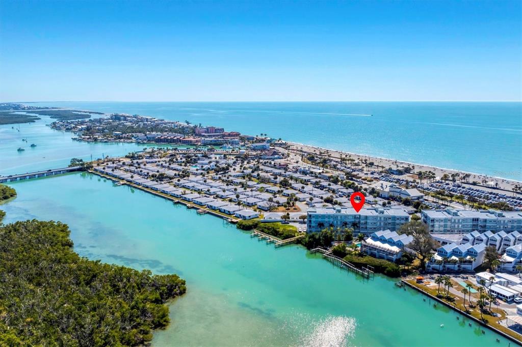 2245 North Beach Road, Unit 203 Englewood, FL 34223 - Photo 2 of 55 an aerial view of a city with lots of residential buildings ocean and mountain view in back