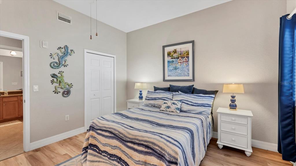 2245 North Beach Road, Unit 203 Englewood, FL 34223 - Photo 23 of 55 a bedroom with a bed and a painting on the wall