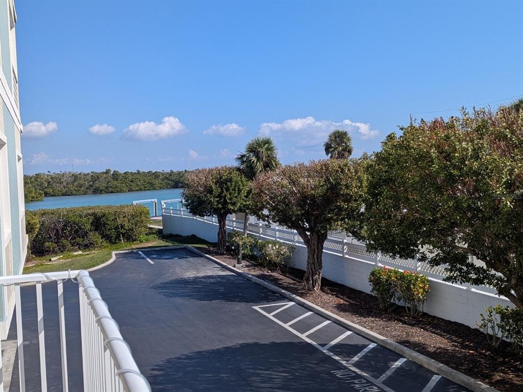 2245 North Beach Road, Unit 203 Englewood, FL 34223 - Photo 29 of 55 a view of a lake with a bench in front of house