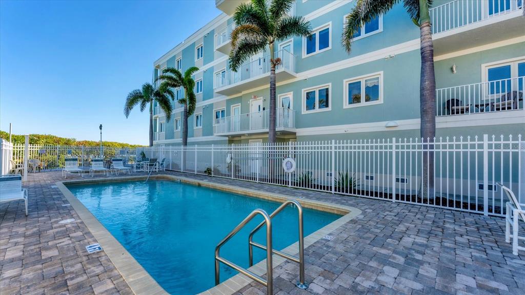 2245 North Beach Road, Unit 203 Englewood, FL 34223 - Photo 31 of 55 a swimming pool with outdoor seating and yard
