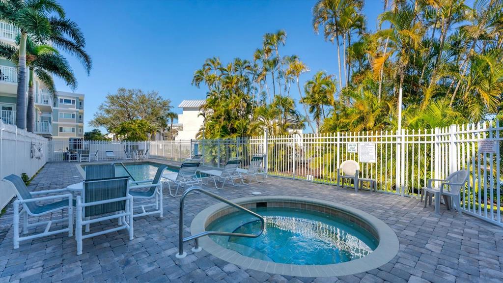 2245 North Beach Road, Unit 203 Englewood, FL 34223 - Photo 32 of 55 a small pool with a table and chairs