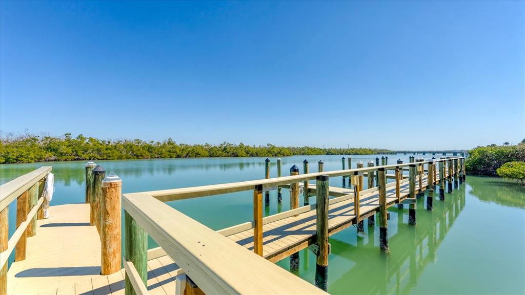 2245 North Beach Road, Unit 203 Englewood, FL 34223 - Photo 35 of 55 a view of a lake with couches chairs