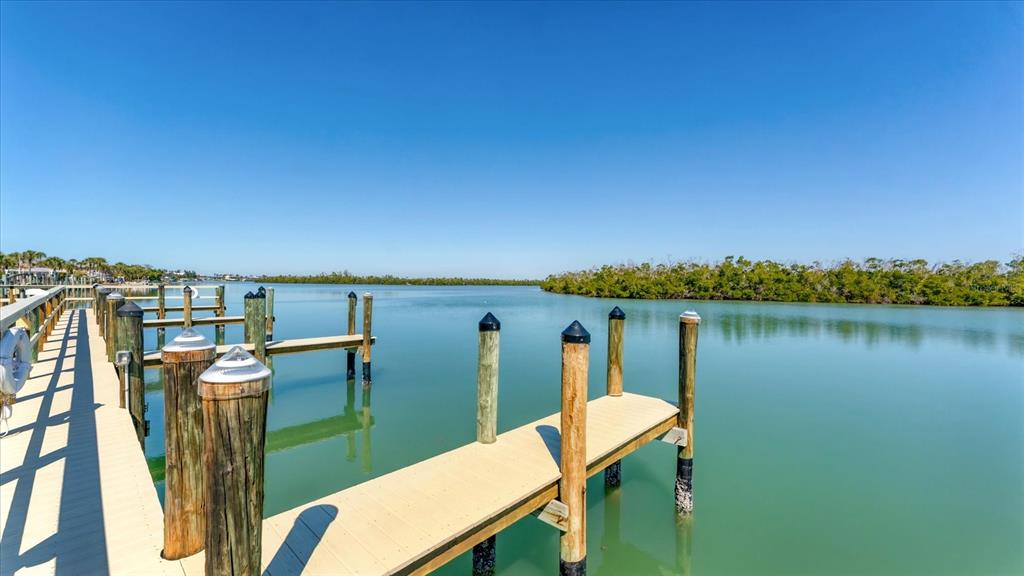 2245 North Beach Road, Unit 203 Englewood, FL 34223 - Photo 38 of 55 a balcony with chairs