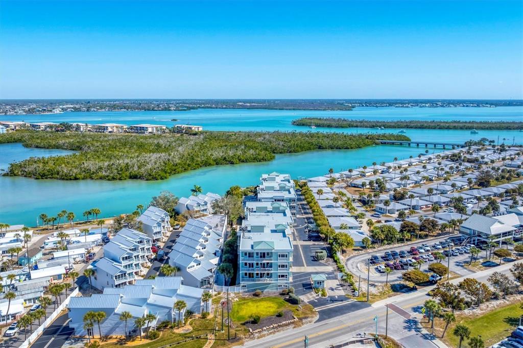 2245 North Beach Road, Unit 203 Englewood, FL 34223 - Photo 51 of 55 an aerial view of a city with lots of residential buildings and lake view in back