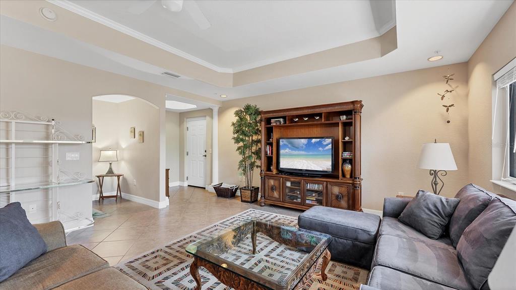 2245 North Beach Road, Unit 203 Englewood, FL 34223 - Photo 8 of 55 a living room with furniture and a flat screen tv