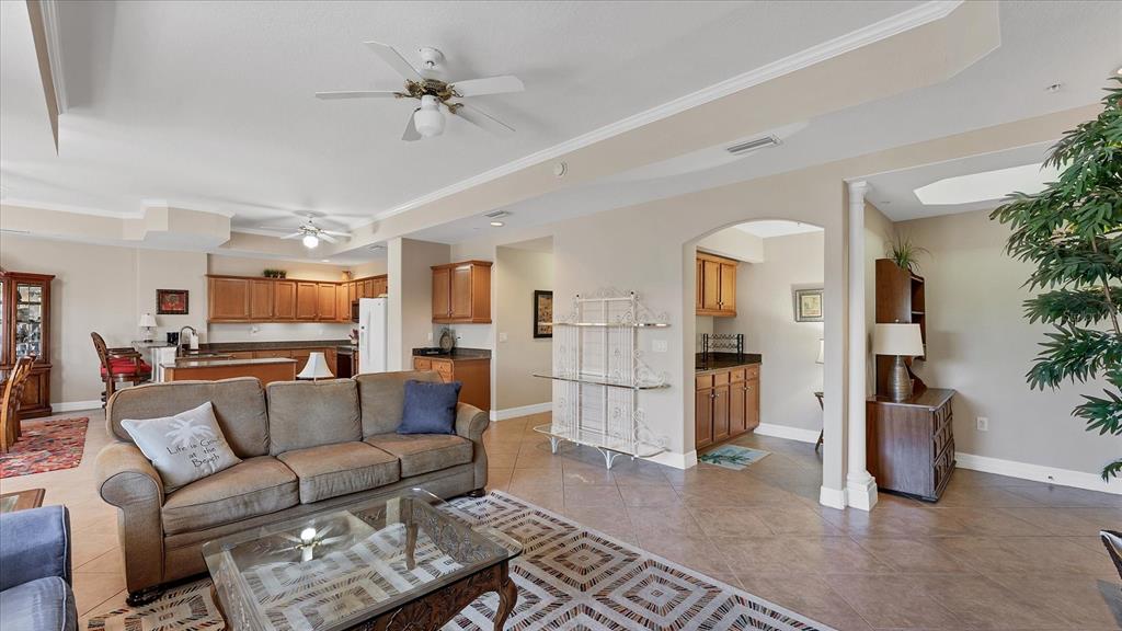 2245 North Beach Road, Unit 203 Englewood, FL 34223 - Photo 10 of 55 a living room with furniture and a chandelier