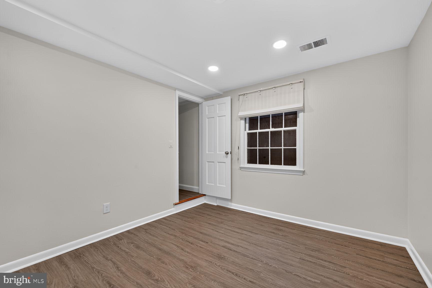4605 Reno Road Northwest Washington, DC 20008 - Photo 41 of 49 wooden floor in an empty room with a window