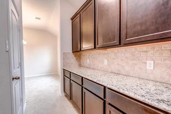 view of kitchen with granite countertop cabinets and sink