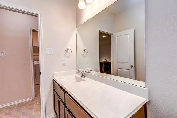 a bathroom with a sink vanity and a mirror