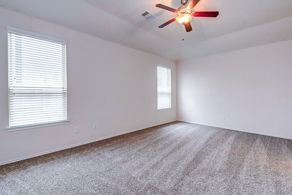 24314 North Newcastle Bay Trail Spring, TX 77389 - Photo 23 of 32 a view of an empty room with window and a chandelier fan
