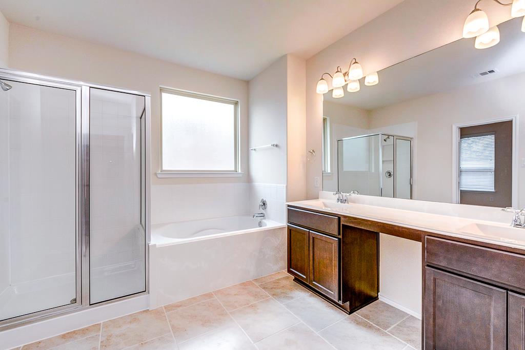 24314 North Newcastle Bay Trail Spring, TX 77389 - Photo 25 of 32 a spacious bathroom with a tub sink and mirror