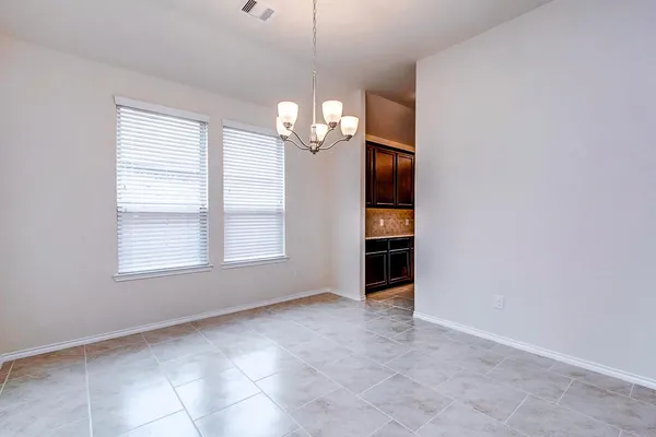 an empty room with windows and entrance