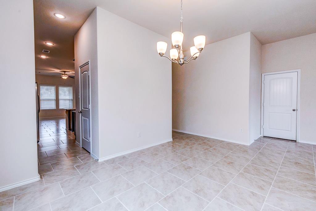 24314 North Newcastle Bay Trail Spring, TX 77389 - Photo 9 of 32 a view of an empty room with a chandelier