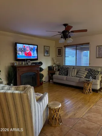 a living room with furniture a flat screen tv and a fireplace
