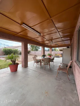 a view of a patio with table and chairs