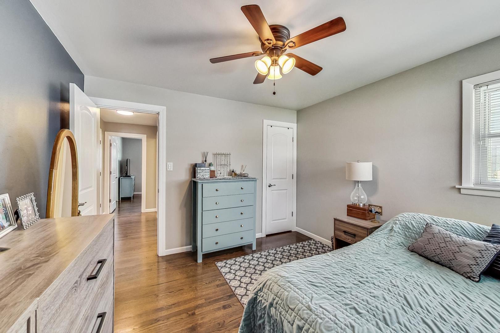824 Florence Drive Park Ridge, IL 60068 - Photo 17 of 45 a bedroom with a bed and a chandelier