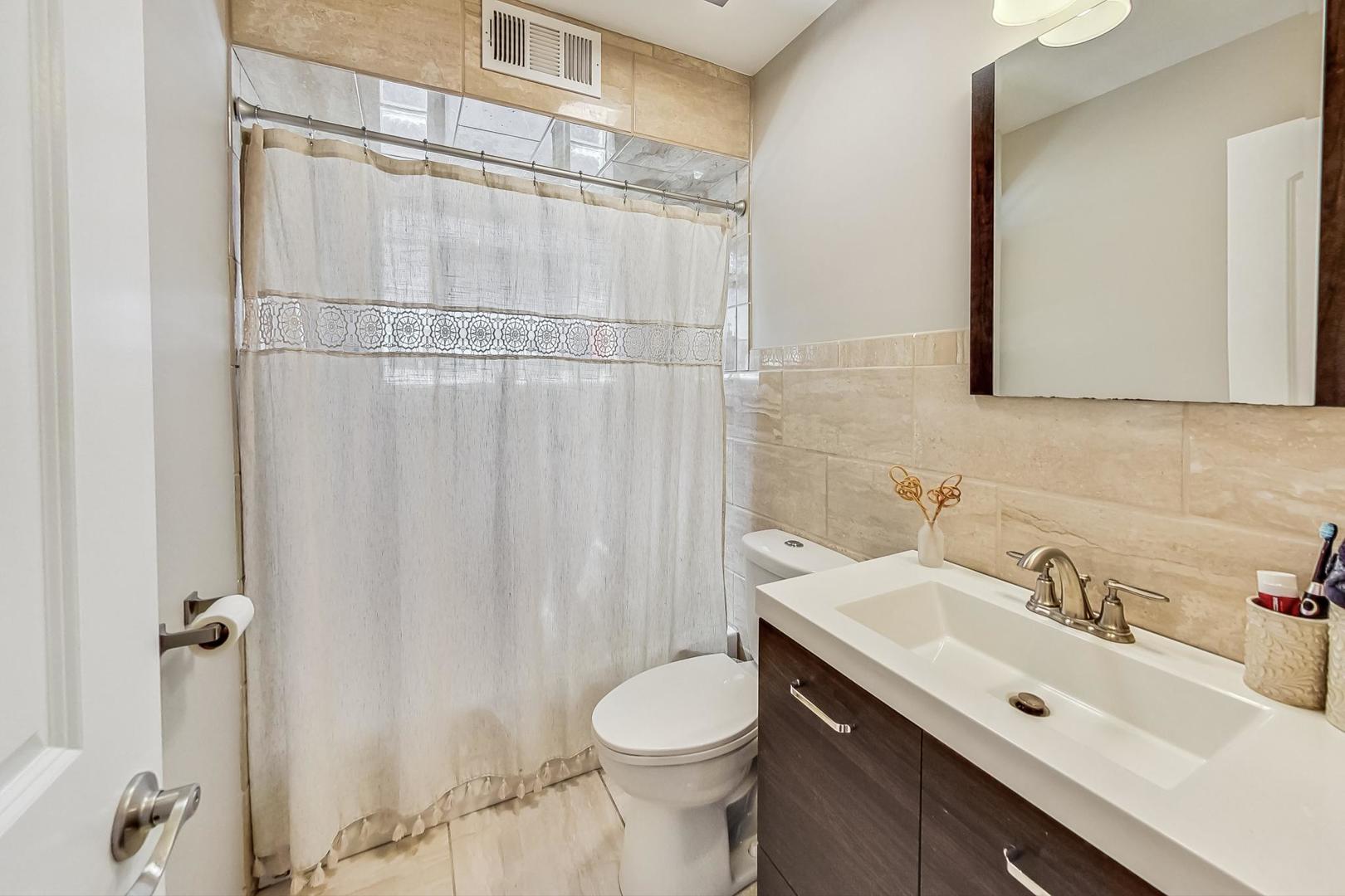 824 Florence Drive Park Ridge, IL 60068 - Photo 21 of 45 a bathroom with a sink vanity mirror and toilet