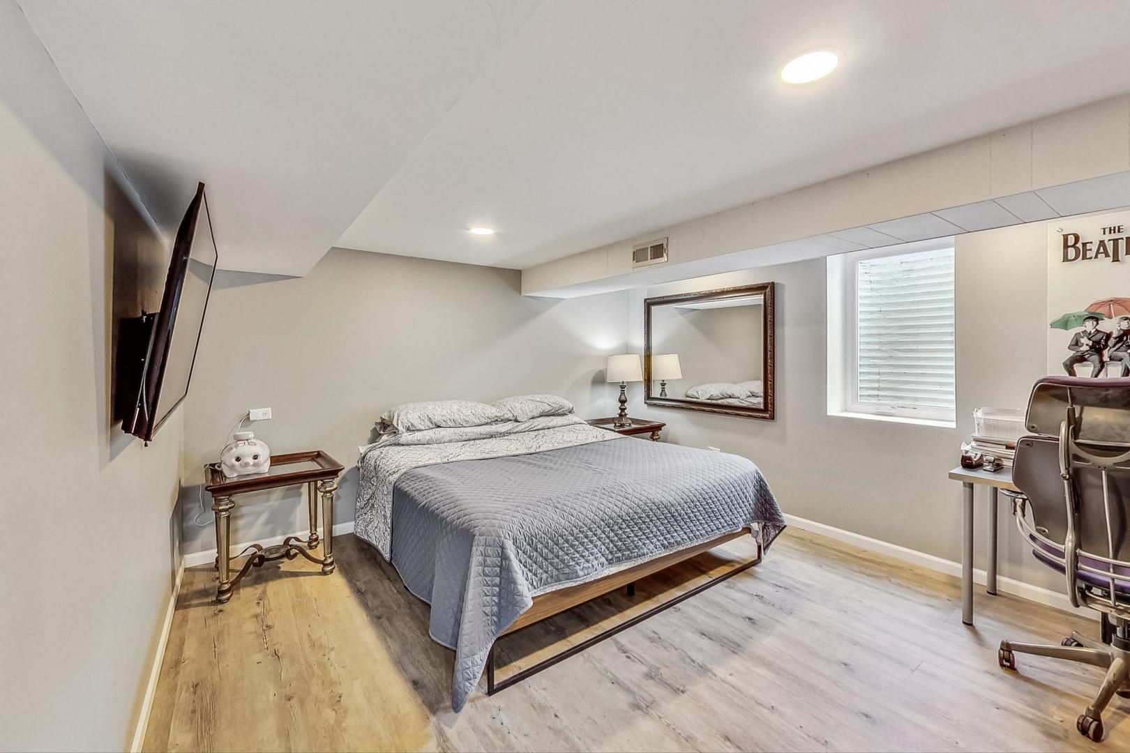 824 Florence Drive Park Ridge, IL 60068 - Photo 29 of 45 a bedroom with a bed and a flat screen tv