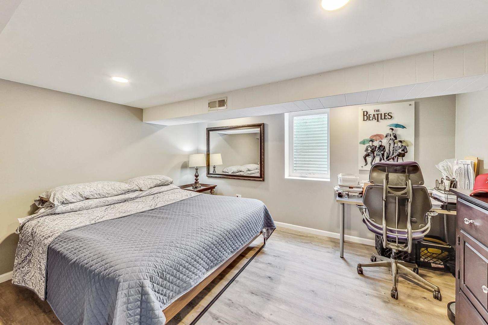 824 Florence Drive Park Ridge, IL 60068 - Photo 30 of 45 a bedroom with a bed a desk and chair with wooden floor