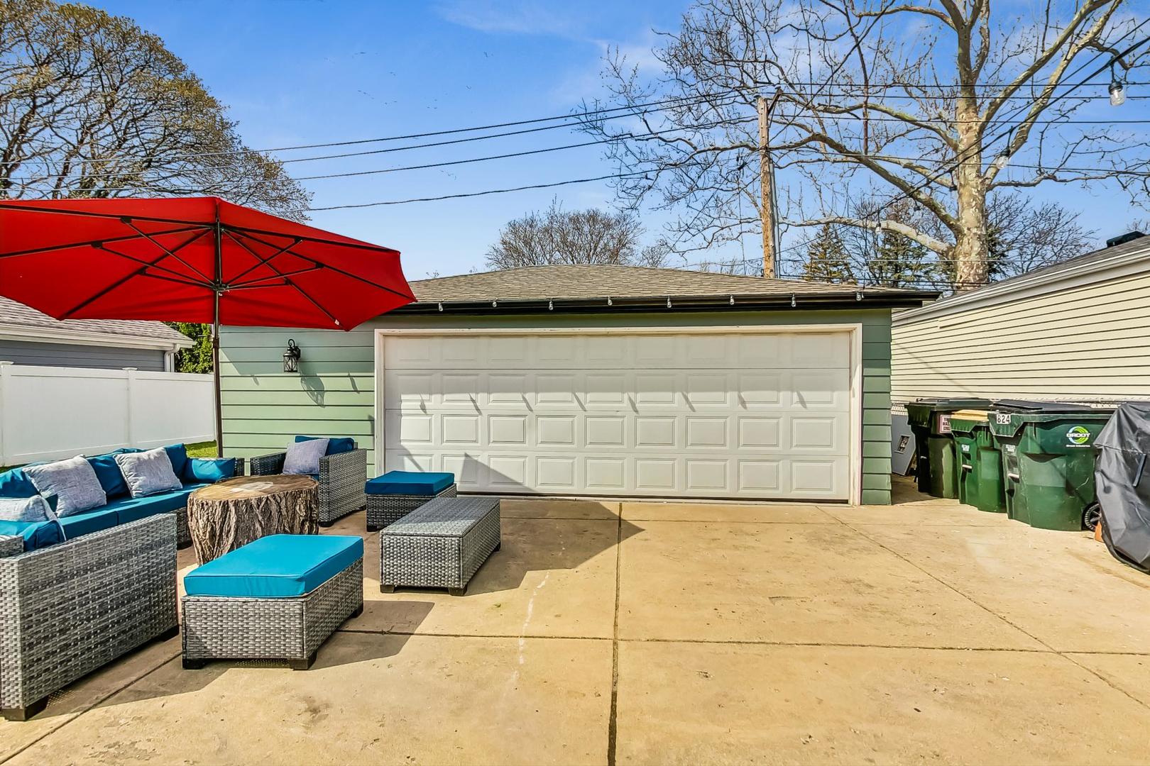 824 Florence Drive Park Ridge, IL 60068 - Photo 37 of 45 a view of a patio with couches chairs under an umbrella