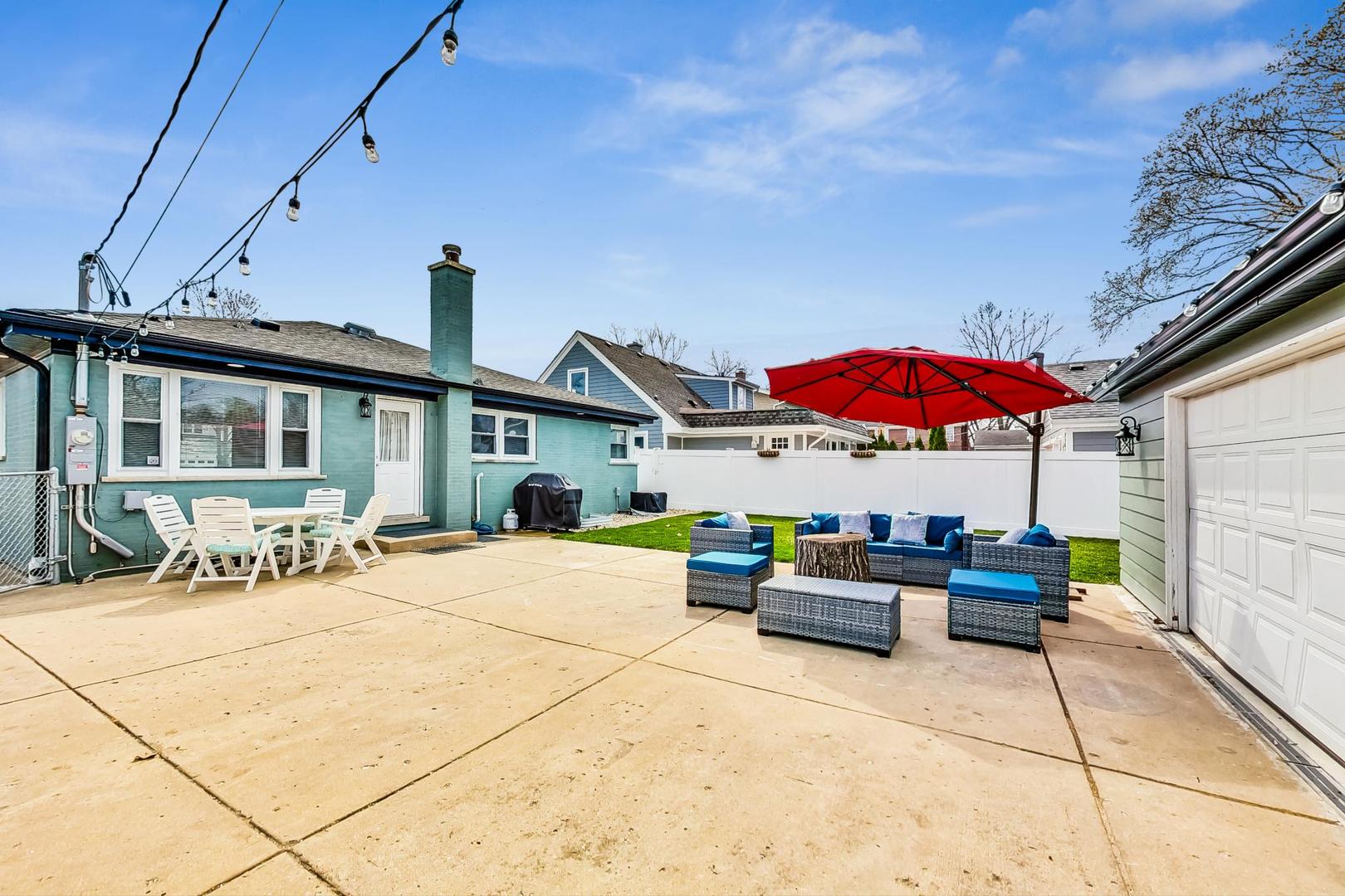824 Florence Drive Park Ridge, IL 60068 - Photo 38 of 45 a view of a patio with a table and chairs under an umbrella