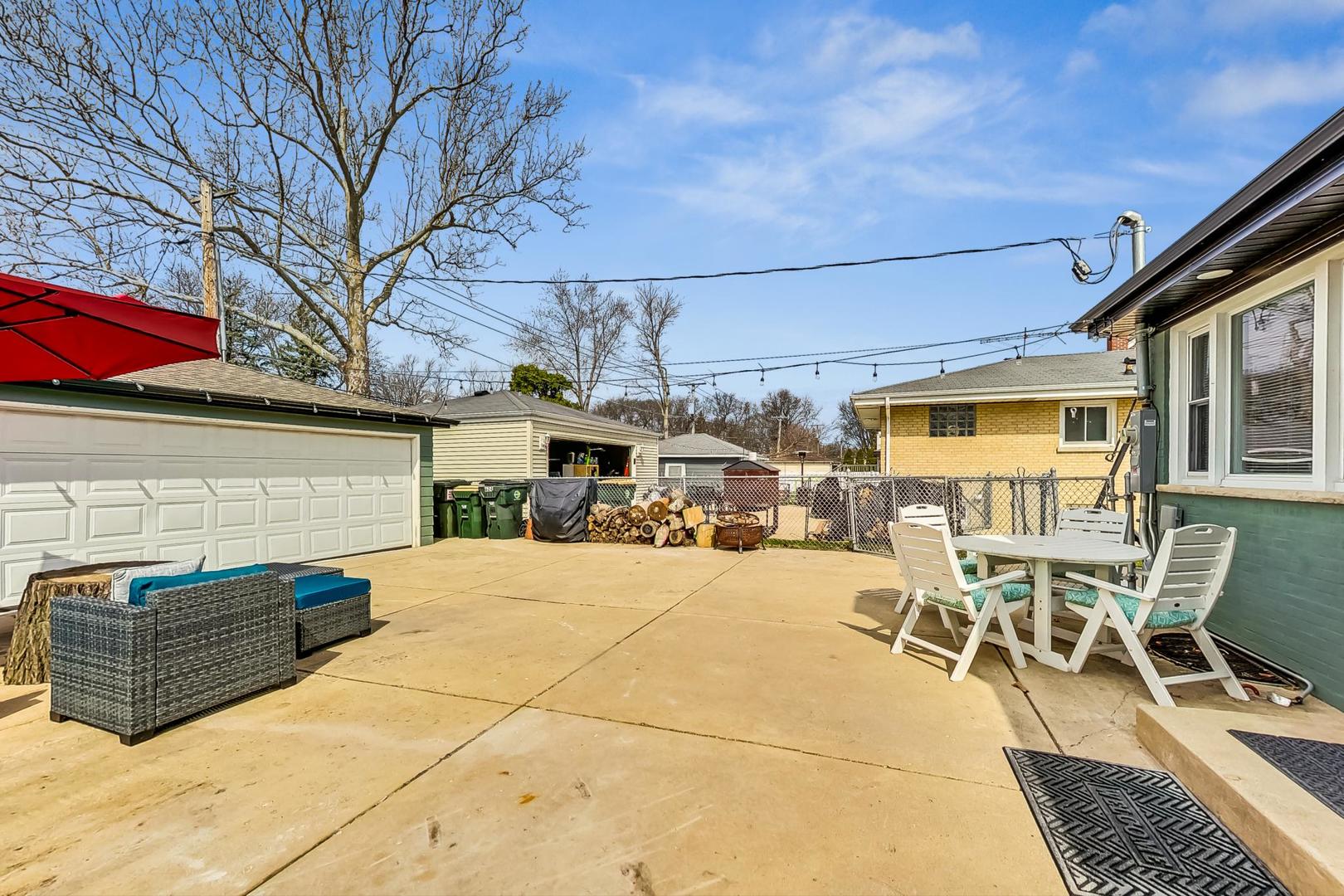 824 Florence Drive Park Ridge, IL 60068 - Photo 39 of 45 a view of a backyard with furniture and a fire pit