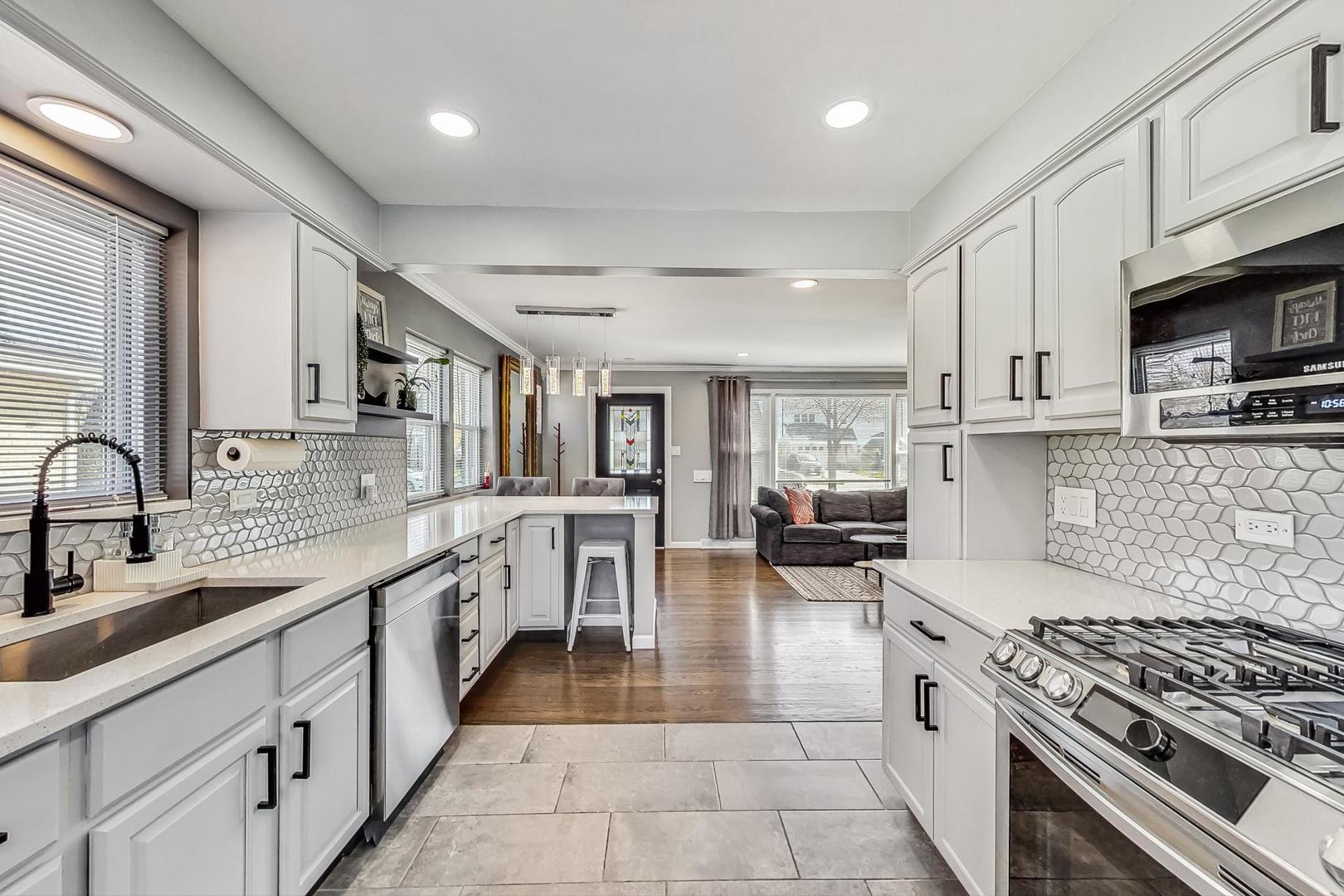 824 Florence Drive Park Ridge, IL 60068 - Photo 10 of 45 a large white kitchen with stainless steel appliances granite countertop a stove and a sink