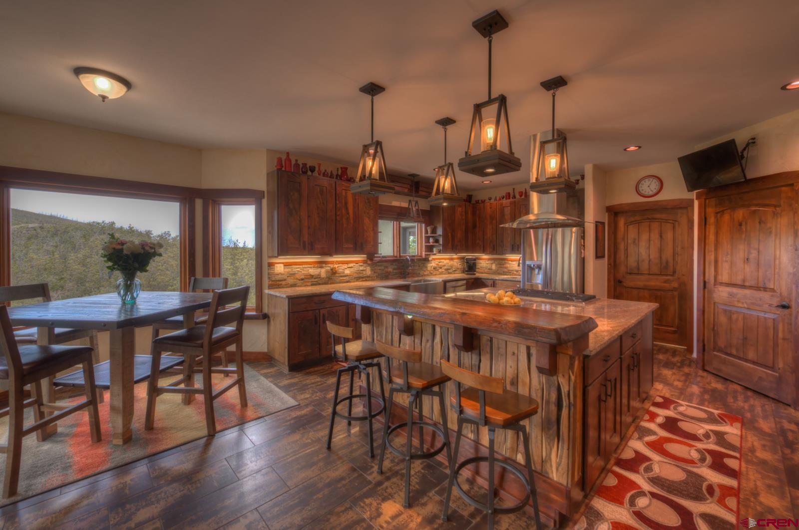 1833 Yellowstone Creek Road Walsenburg, CO 81089 - Photo 15 of 44 a view of a dining room with furniture and wooden floor