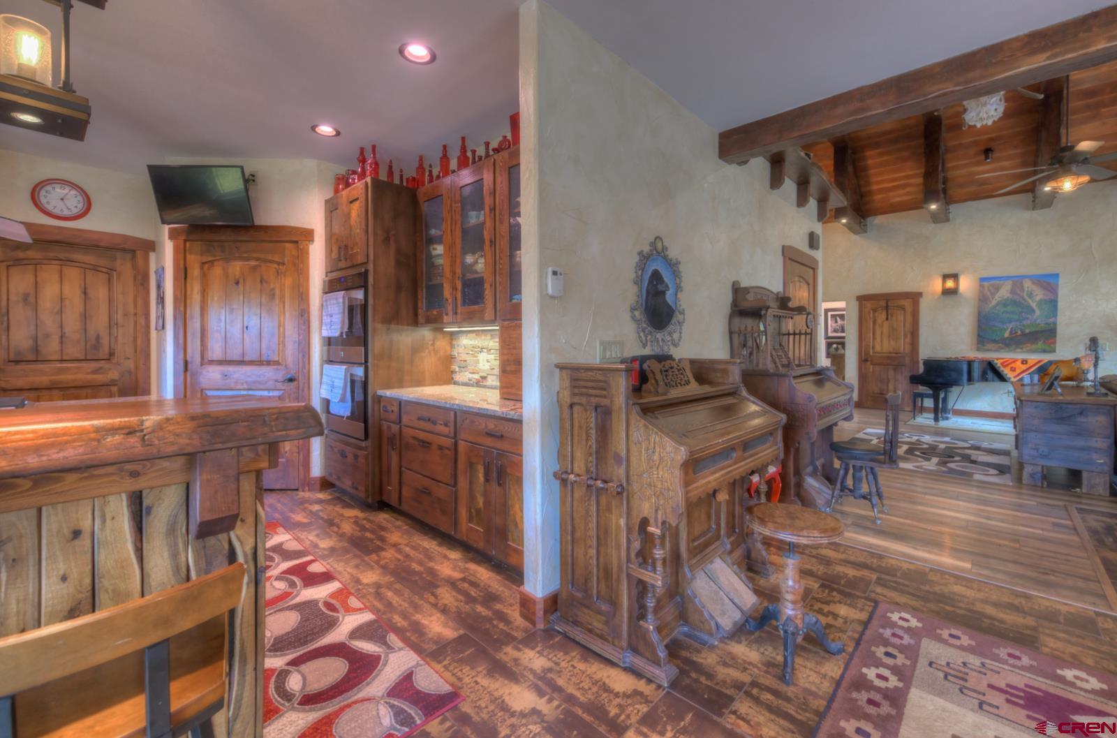 1833 Yellowstone Creek Road Walsenburg, CO 81089 - Photo 19 of 44 a living room with furniture and a dining table with kitchen view