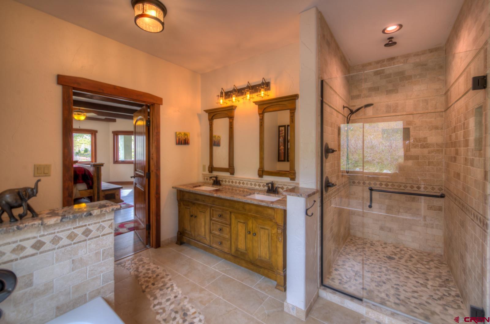 1833 Yellowstone Creek Road Walsenburg, CO 81089 - Photo 25 of 44 a en suite bathroom with a granite countertop sink mirror and bathtub