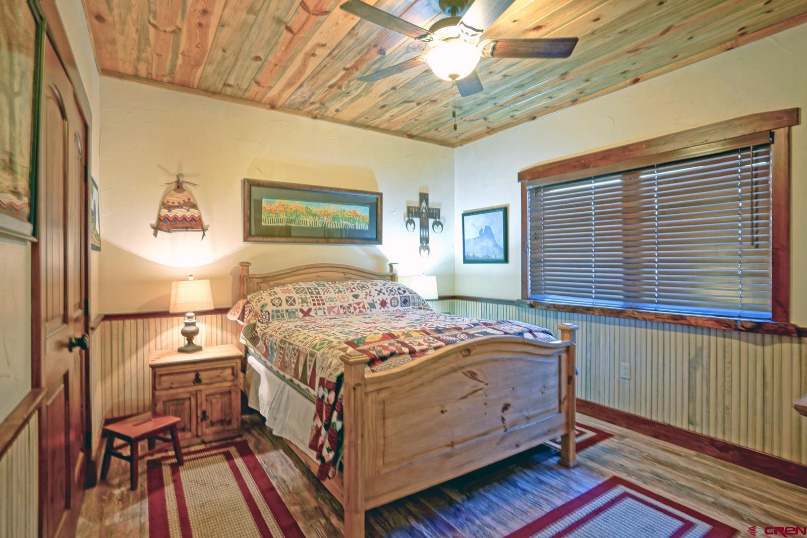 1833 Yellowstone Creek Road Walsenburg, CO 81089 - Photo 31 of 44 a bedroom with a bed and a chandelier