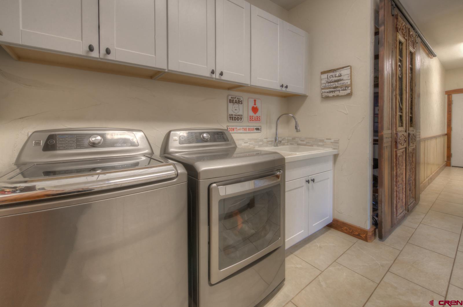 1833 Yellowstone Creek Road Walsenburg, CO 81089 - Photo 41 of 44 a utility room with dryer and washer