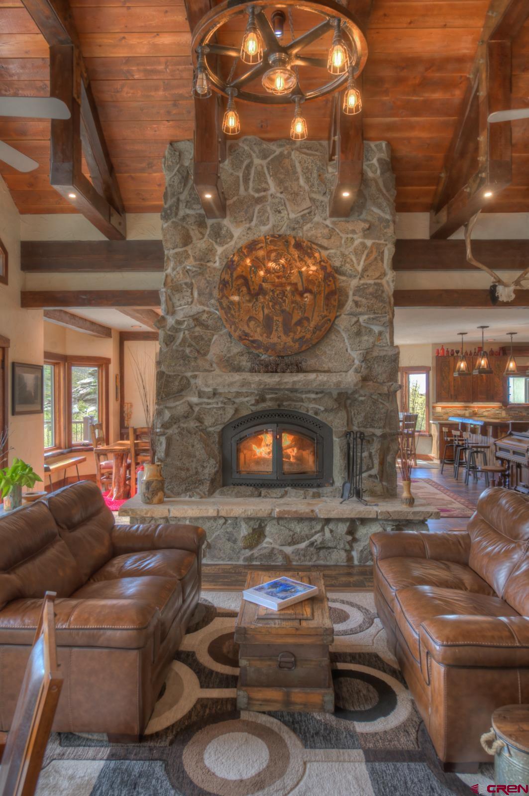 1833 Yellowstone Creek Road Walsenburg, CO 81089 - Photo 6 of 44 a living room with furniture and a fireplace