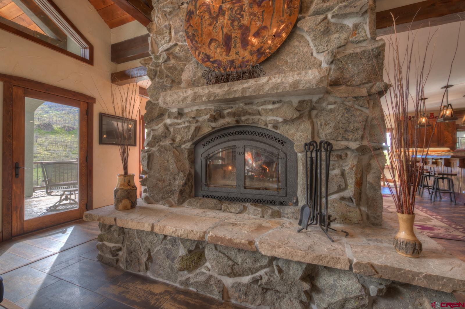 1833 Yellowstone Creek Road Walsenburg, CO 81089 - Photo 8 of 44 a bedroom with a bed and a fireplace